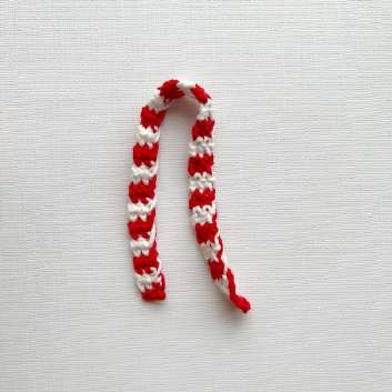 Finished crochet Plush Grinch amigurumi with striped red and white scarf