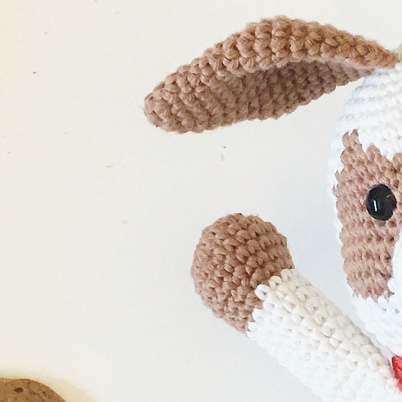 Macro detail of crochet puppy floppy chocolate brown ear