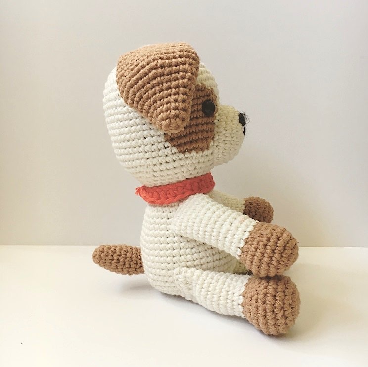 Close-up of Puppy Chip amigurumi dog showing the brown eye patch tapestry crochet