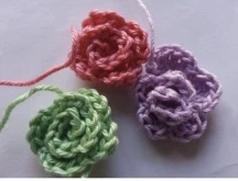 Pastel pink green and purple crochet flower rosettes for unicorn crown