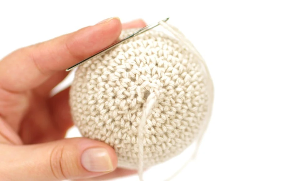 Safety eyes placement and stuffing of crochet teddy bear head